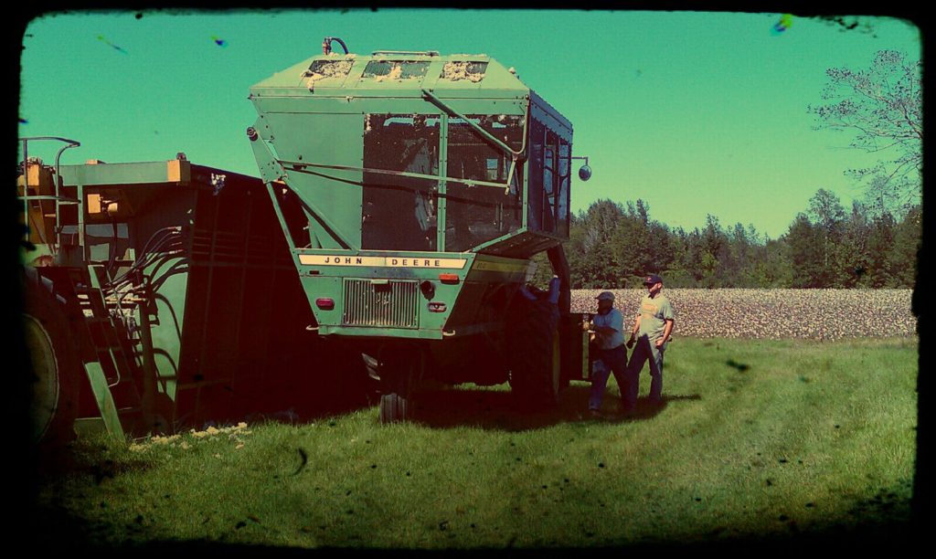 Clyde and Joe working on a cotton picker